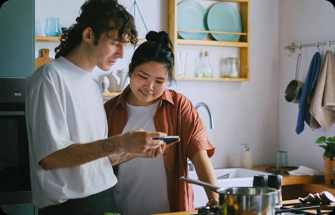 Two people learning together using a mobile device.
